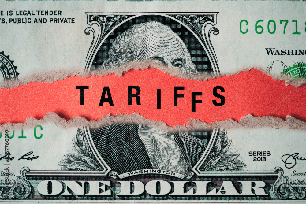 Fototapeta premium Tariffs wording on USD dollar banknote torn for united stats of America announced tax barrier of imports goods from every countries of trade war concept.