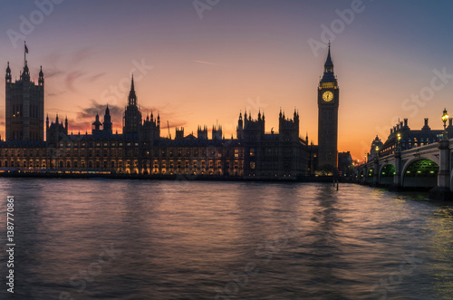 A long exposure of the Big Ben tower and the Palace of Westminster during a colorful sunset