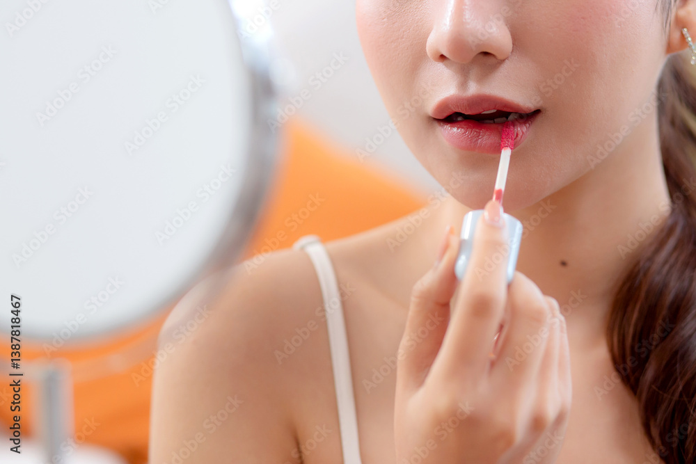 Closeup hands beauty young asian woman applying makeup with lipstick looking mirror in living room at home, beauty woman applying make-up with cosmetic on facial for glamour, make up and cosmetic. Closeup hands beauty young asian woman applying makeup with lipstick looking mirror in living room at home, beauty woman applying make-up with cosmetic on facial for glamour, make up and cosmetic.