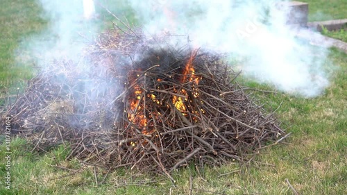 A burning pile of dry branches. A bonfire made of thin, dry branches