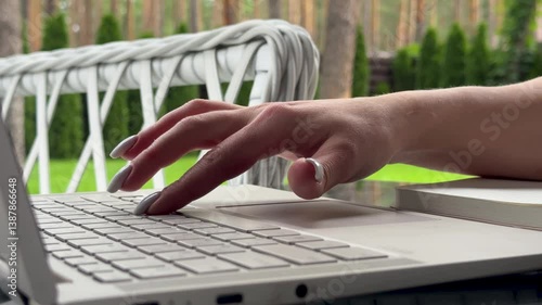 Close up of freelancer's developer hands typing program code on laptop keyboard in coworking. Copywriter writing text on computer keyboard. Female Hands Typing on Laptop Keyboard Close Up