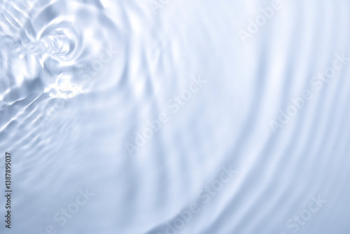 Soft Ripple Effects on Calm Water Surface in Bright Blue Hue