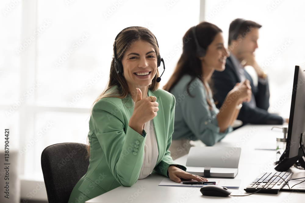 Cheerful Hispanic call center professional woman posing for business portrait at workplace, showing thumb up like hand gesture at camera, recommending job in company, technical support service Cheerful Hispanic call center professional woman posing for business portrait at workplace, showing thumb up like hand gesture at camera, recommending job in company, technical support service