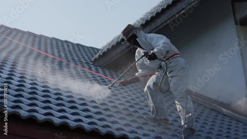 Wallpaper Mural Professional painter on roof Working at heights is dangerous.	 Torontodigital.ca