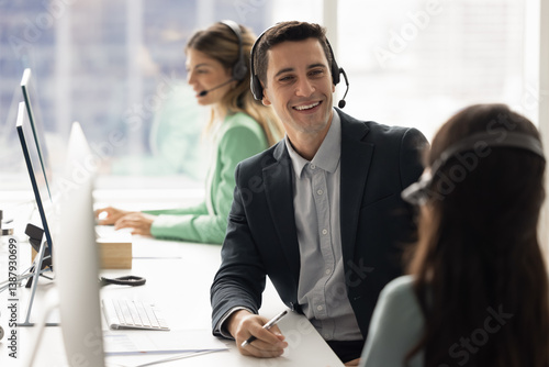 Foto Happy contact center colleagues wearing headsets talking at workplace, consultin