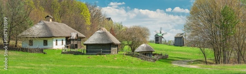 panoramic view to old village with wooden houses and mills on the hill in spring day