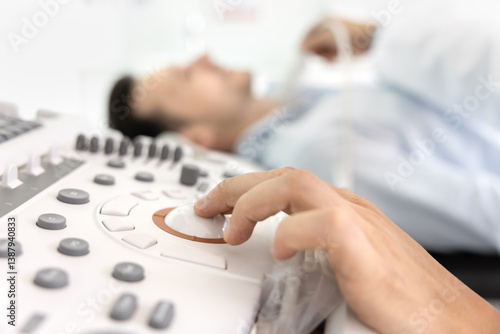 Fotografi Close up of doctor hand adjusting controls on ultrasound machine, perform diagnostic scan, patient lying down, receiving thyroid examination with probe applied to his neck