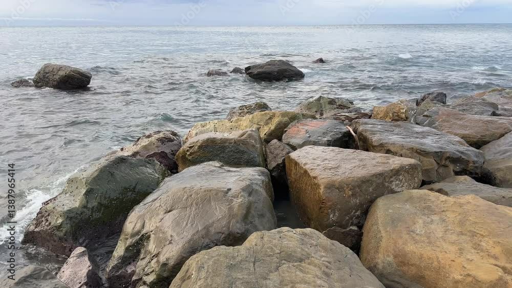Stones near shore washed by sea water in overcast morning Stones near shore washed by sea water in overcast morning