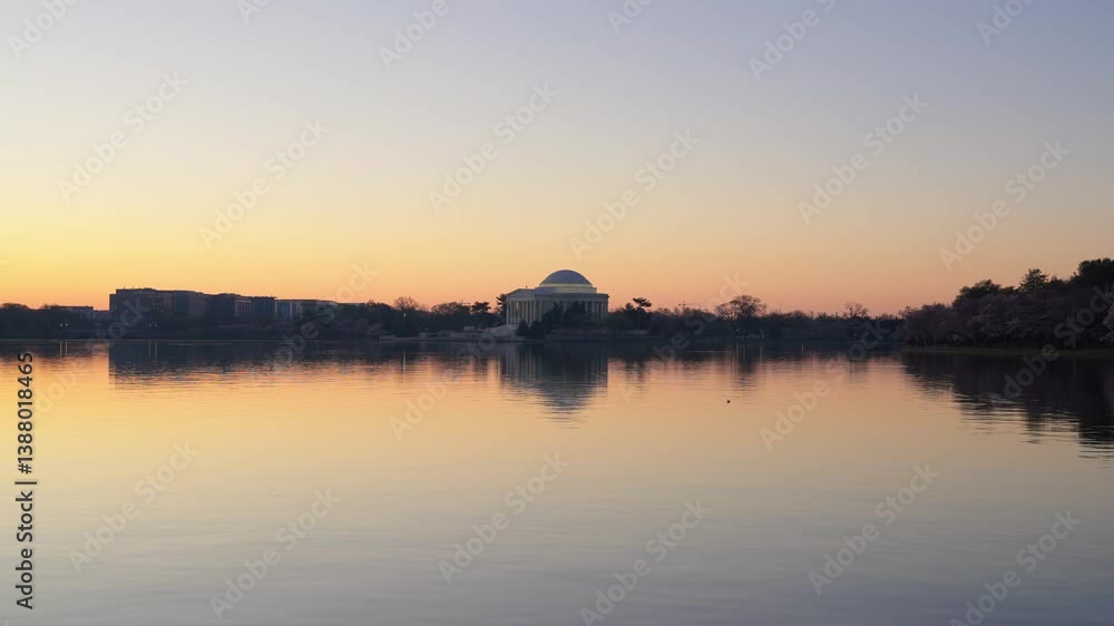 Tidal basin in Washington DC and the Jefferson Memorial at sunrise during peak cherry blossom bloom. Tidal basin in Washington DC and the Jefferson Memorial at sunrise during peak cherry blossom bloom.