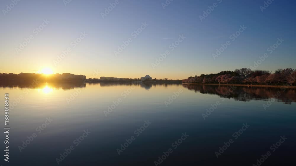 Tidal basin in Washington DC and the Jefferson Memorial at sunrise during peak cherry blossom bloom. Tidal basin in Washington DC and the Jefferson Memorial at sunrise during peak cherry blossom bloom.