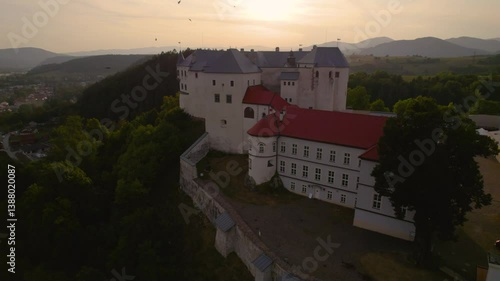 Monumental medieval castle at sunset, beautiful breathtaking drone shot. Lupčiansky hrad, Slovakia. 