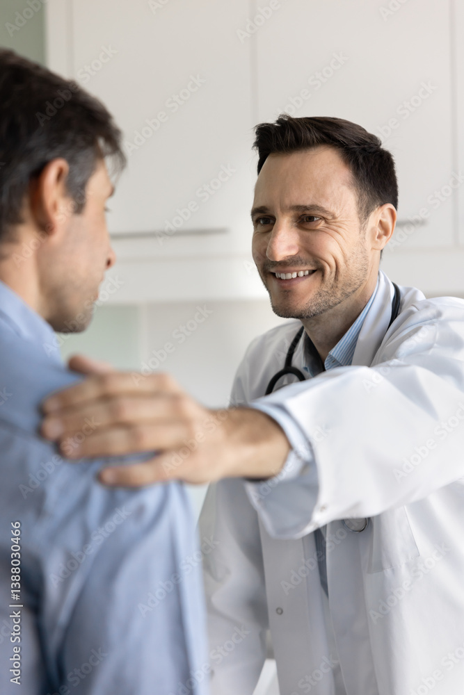 Close up friendly physician in white coat speak with sad male patient, touches his shoulder in gesture of encouragement, emotional support. Empathy, reassurance, and doctor-patient relations and trust Close up friendly physician in white coat speak with sad male patient, touches his shoulder in gesture of encouragement, emotional support. Empathy, reassurance, and doctor-patient relations and trust