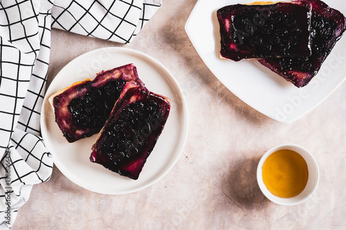 Blueberry upside down pies on a plate on a table top view