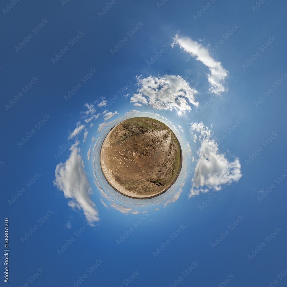 simple little tiny planet without buildings in blue sky with sun and beautiful clouds. Transformation of spherical panorama 360 degrees. Spherical abstract aerial view. Curvature of space.