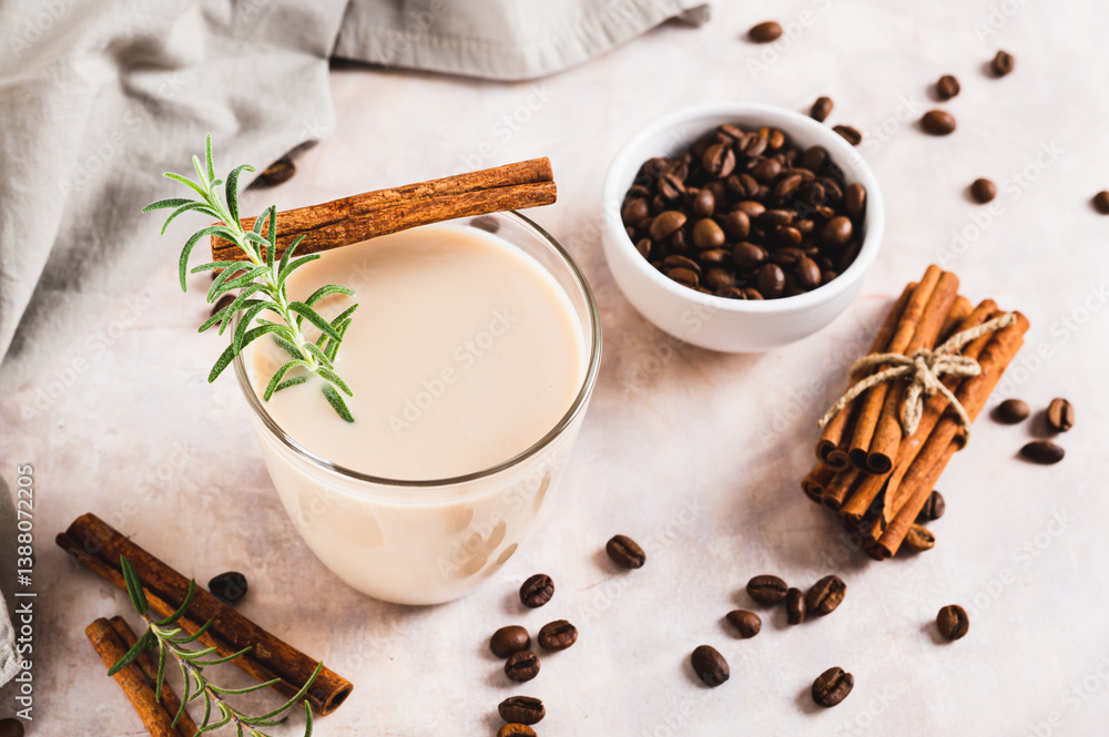 Cup of iced latte with rosemary and cinnamon on the table