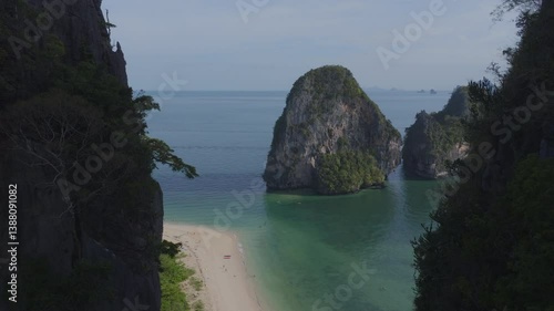 drone shot of a beach with crystal clear blue water and limestone cliffs in Krabi, Thailand. Railay Beach.