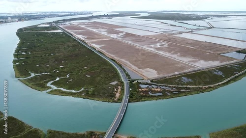 Aerial drone view of empty sea salt marshes in Marismas del Odiel wetlands. Natural salt produced by the evaporation of seawater. Traditional and natural salt production in nature reserve, in Huelva
