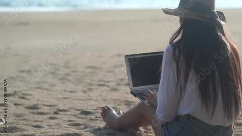 Young freelance women working with her laptop on holiday at the beach .