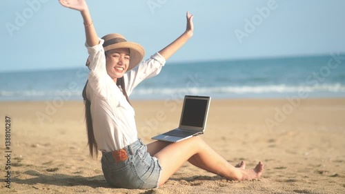 Young freelance women working with her laptop on holiday at the beach .