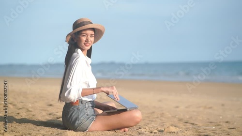 Young freelance women working with her laptop on holiday at the beach .
