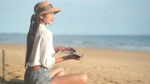 Young freelance women working with her laptop on holiday at the beach .