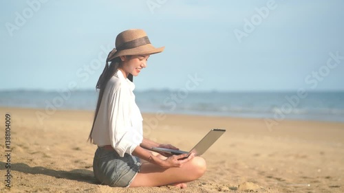 Young freelance women working with her laptop on holiday at the beach .