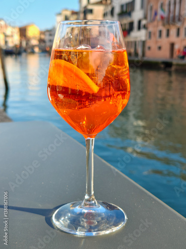Wallpaper Mural A glass of Aperol spritz cocktail on the table of a Venetian cafe. Venetian background Torontodigital.ca
