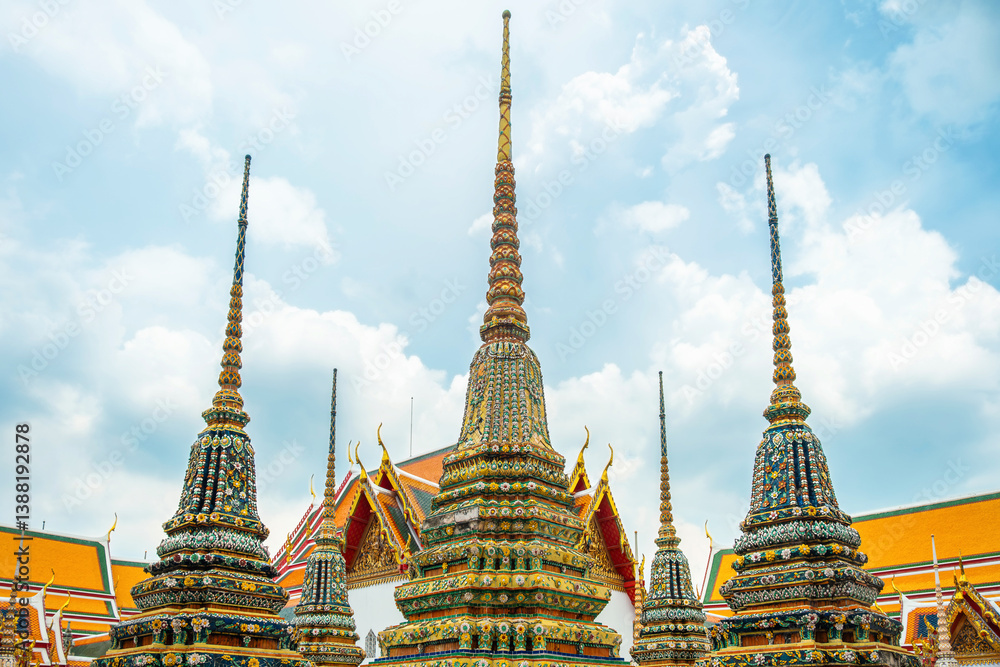 Fototapeta premium Group of Thai Stupas Phra Chedi Rai in Wat Pho Temple Complex in Bangkok city, Thailand. Traditional Buddhist architecture, Asia. Temple of the Reclining Buddha. Popular travel landmark
