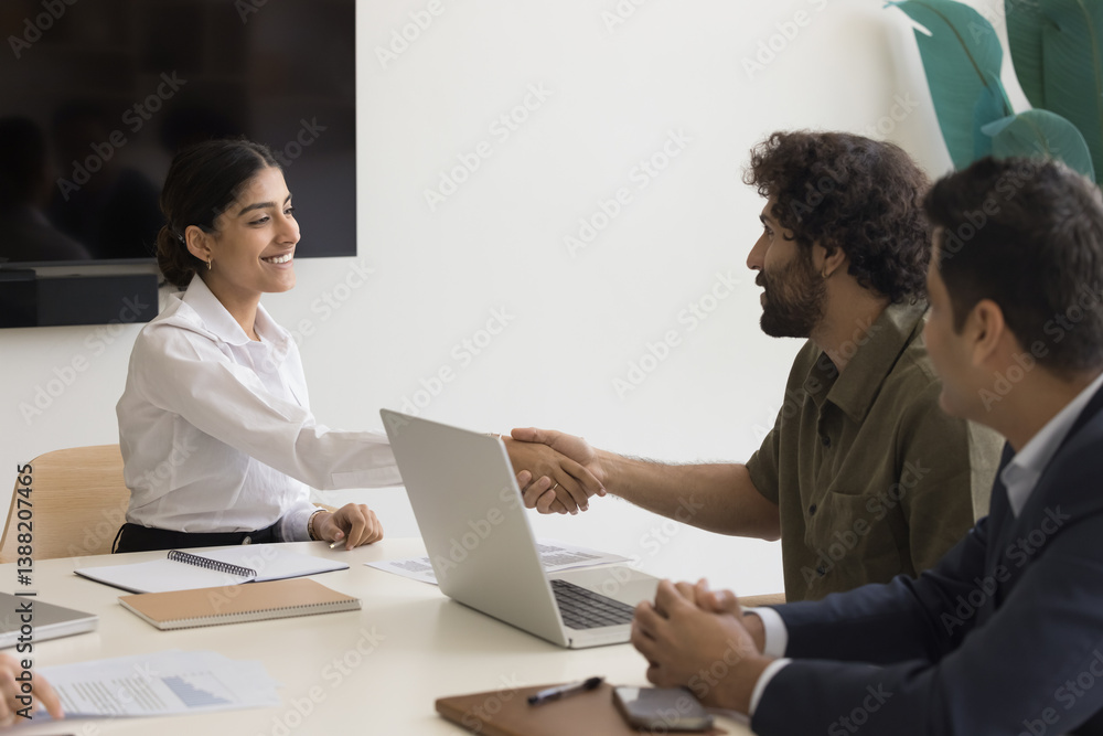 Indian female shaking hand Arabian colleague, greeting each other starting formal meeting, negotiations process or job interview. Make deal, conclude partnership, buying or selling company services Indian female shaking hand Arabian colleague, greeting each other starting formal meeting, negotiations process or job interview. Make deal, conclude partnership, buying or selling company services