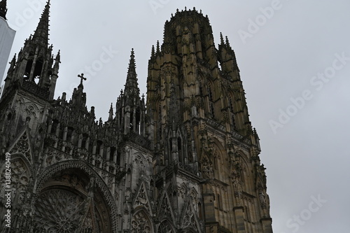 Fototapeta Naklejka Na Ścianę i Meble -  Historic streets of Rouen old town with medieval buildings and gothic cathedral towers. Traditional French architecture in Normandy under cloudy sky, symbol of European heritage and culture.