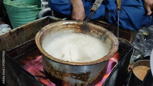 Traditional Cooking of Food in a Pot Over Fire