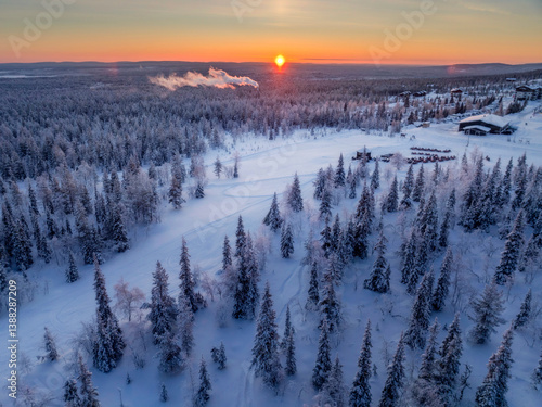 Aerial view of beautiful winter landscape in Lapland during sunset.