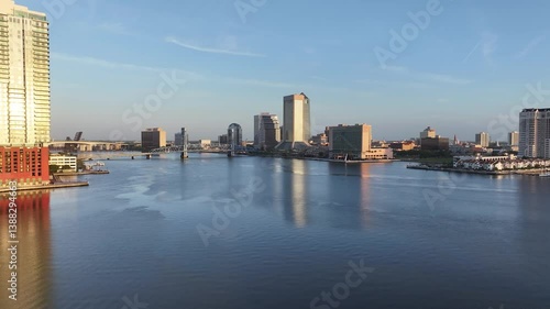 Cityscape view from San Marco and downtown Jacksonville, Florida, on a beautiful blue-sky spring day, with the river, John T. Alsop Jr. Bridge, and tall buildings.