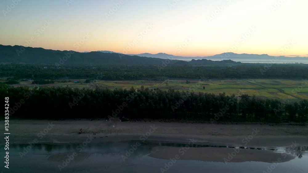 Aerial View of Coastal Beach at Sunset with Forest and Field Aerial View of Coastal Beach at Sunset with Forest and Field