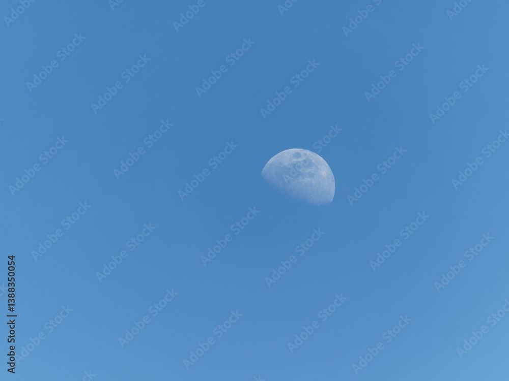 Half moon on a clear blue sky Half moon on a clear blue sky