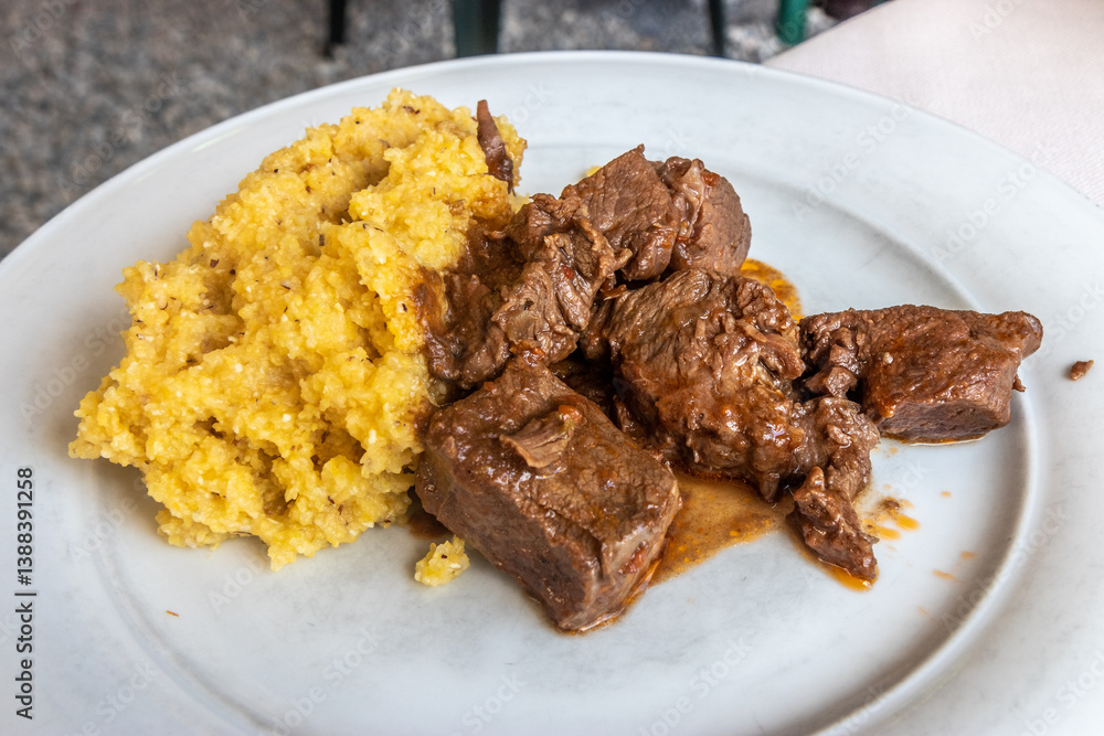 Typical dish of Bergamo - braised beef in red wine with polenta Typical dish of Bergamo - braised beef in red wine with polenta