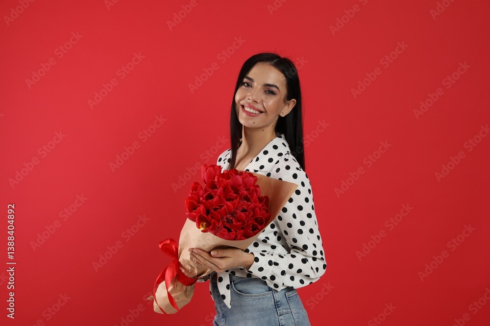 Happy woman with tulip bouquet on red background. 8th of March celebration Happy woman with tulip bouquet on red background. 8th of March celebration