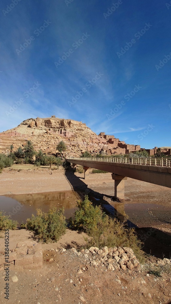 Ancient Desert Fortress and Bridge Under Blue Sky . Ait Ben Haddou, Morocco
