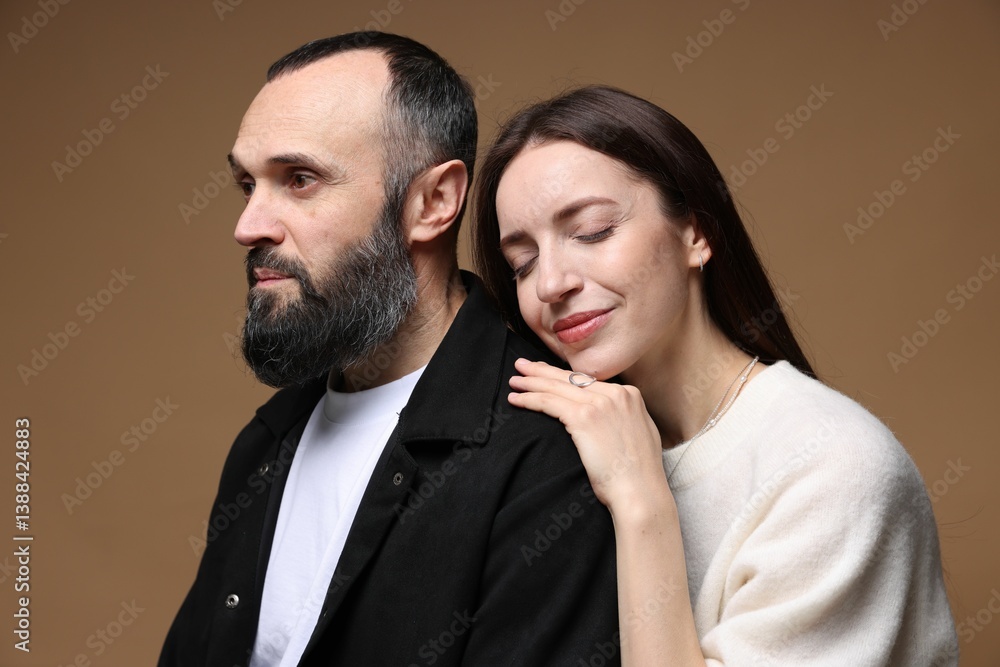 Cute daughter and father on brown background Cute daughter and father on brown background