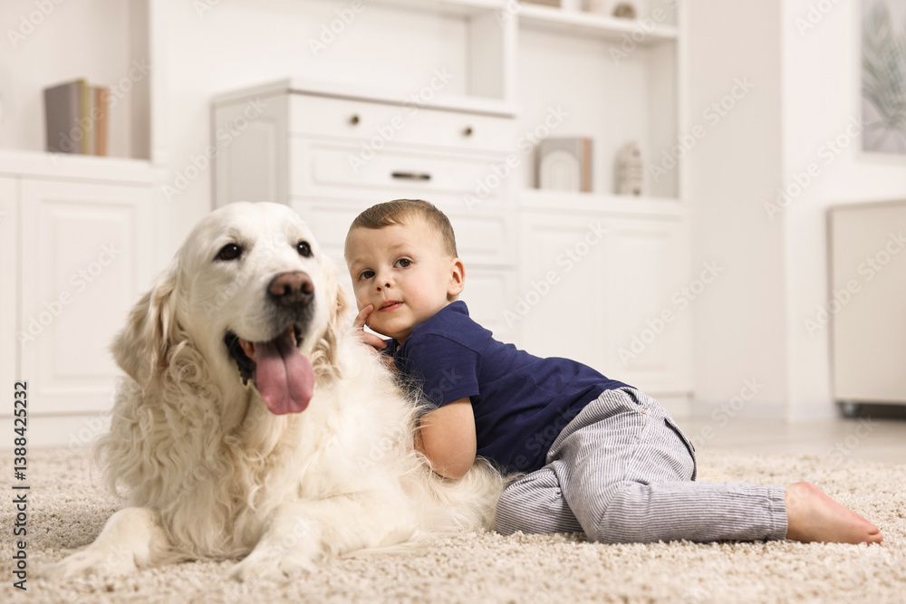 Little boy with cute dog on carpet at home Little boy with cute dog on carpet at home