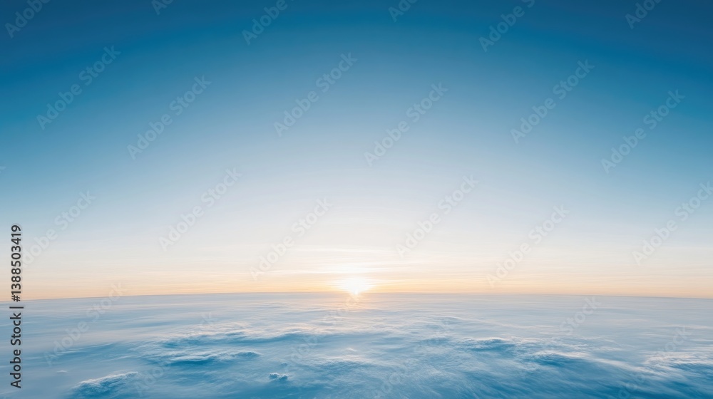 A high-resolution photo depicts a sunrise over a vast expanse of clouds. The sun is low on the horizon, casting a warm glow. The sky is a clear, bright blue. The image features a serene and peacefu A high-resolution photo depicts a sunrise over a vast expanse of clouds. The sun is low on the horizon, casting a warm glow. The sky is a clear, bright blue. The image features a serene and peacefu