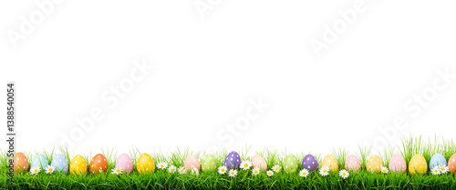 colorful easter eggs with daisies in green grass for spring celebration