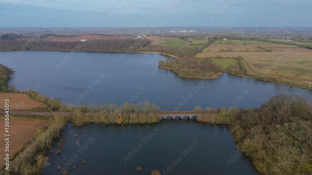 Stunning aerial view of a large reservoir surrounded by forests and quiet countryside, UK. Stunning aerial view of a large reservoir surrounded by forests and quiet countryside, UK.
