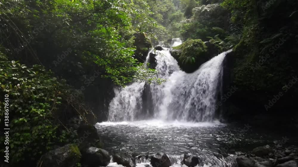 Aerial scenery of hidden and beautiful three-layer waterfall in the middle of forest. Drone footage Aerial scenery of hidden and beautiful three-layer waterfall in the middle of forest. Drone footage