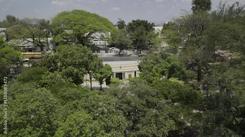 Drone flies backwards over Parque Cuscatlan in downtown San Salvador, El Salvador on sunny day Drone flies backwards over Parque Cuscatlan in downtown San Salvador, El Salvador on sunny day