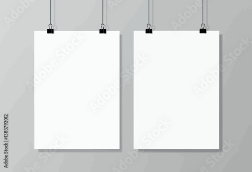 Two White Posters Hanging with Black Clips on Gray Wall