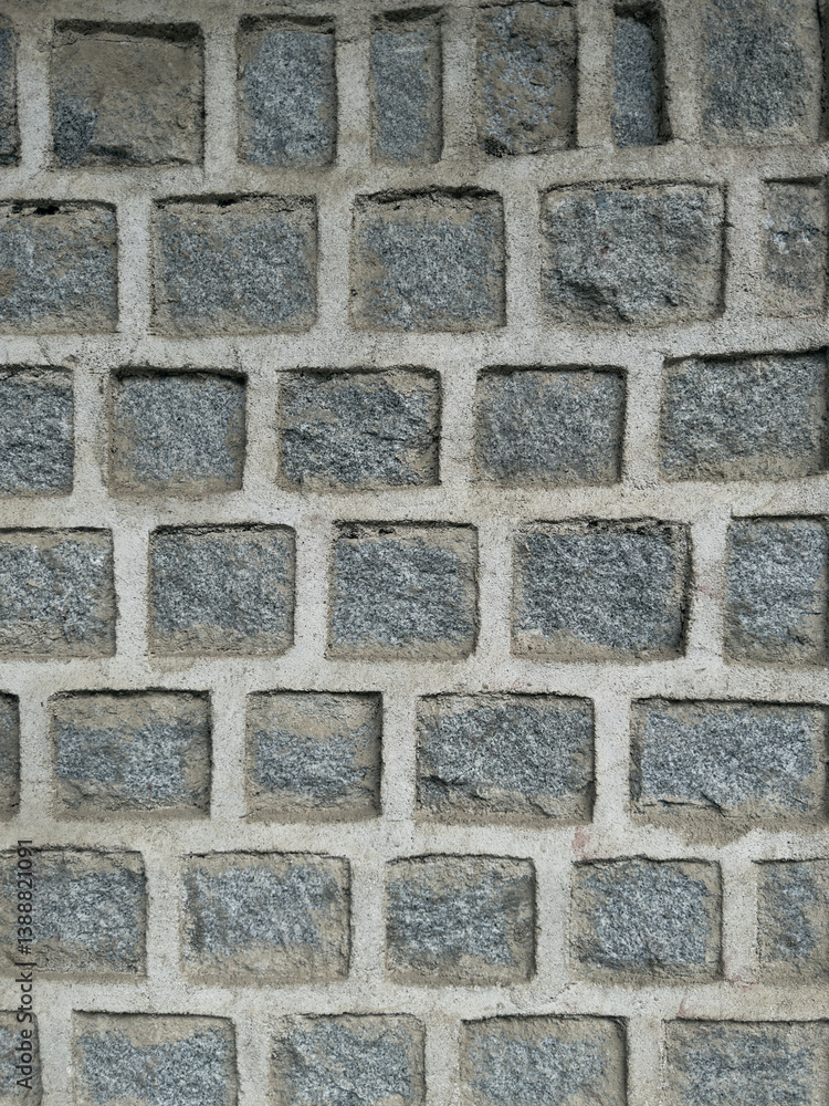 Obraz premium A rough and cracked earthy surface, featuring a mix of concrete-like texture. The natural tones of brown, beige, and tan emphasize the arid, aged look.