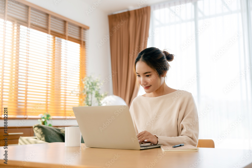 Beautiful young Asian woman working with laptop computer in living room. Work at home Beautiful young Asian woman working with laptop computer in living room. Work at home