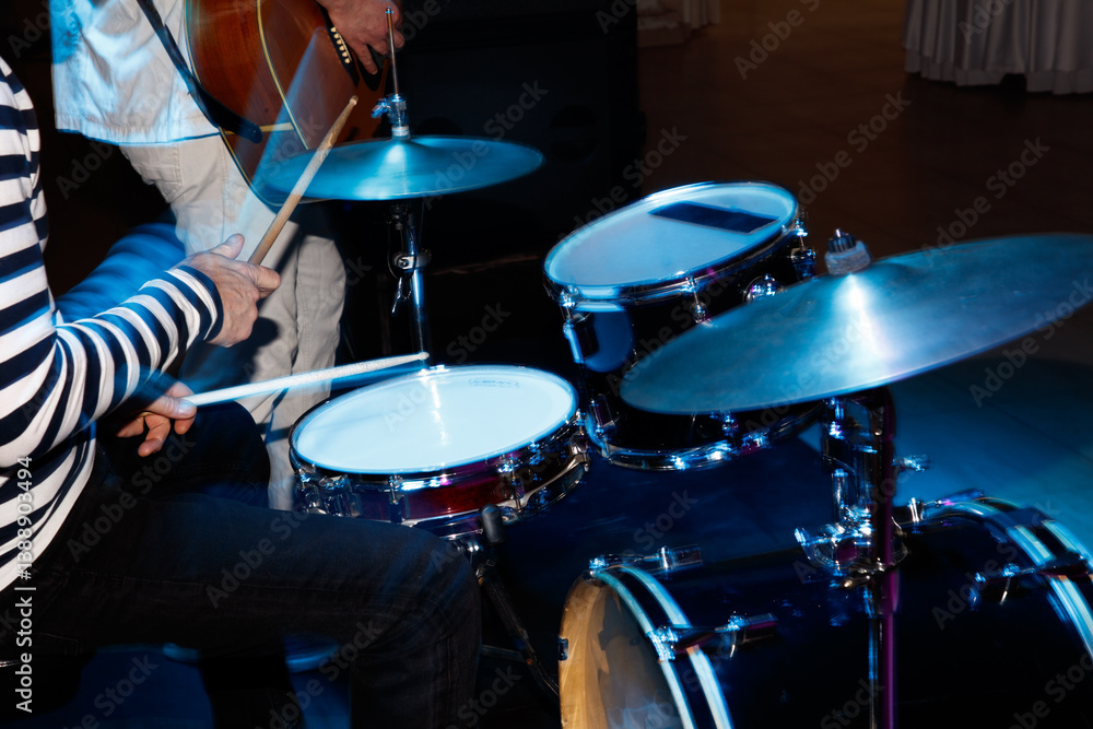 Fototapeta premium A man is playing drums in a band