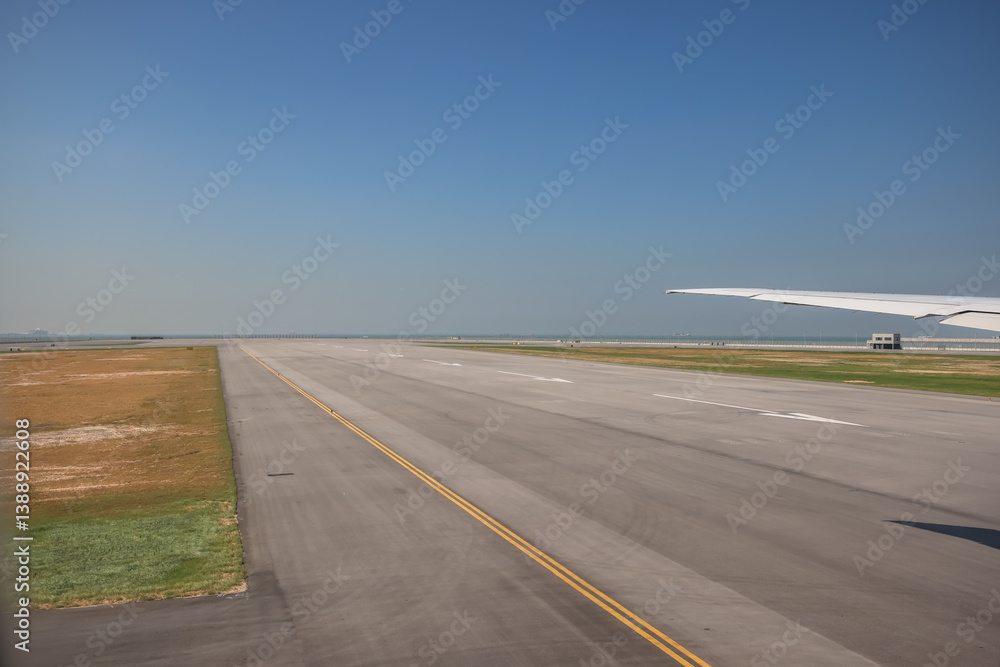 Fototapeta premium Airport Airfield with Runway, and Airplane Wing at HK Dec 3 2024